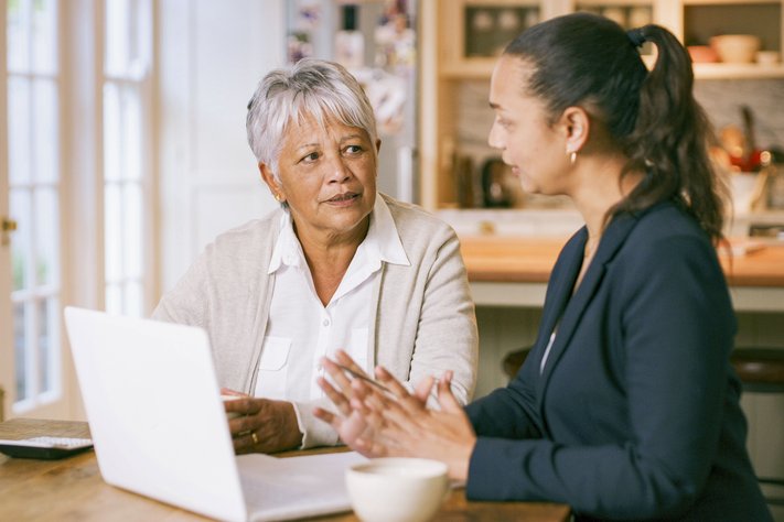 A female lawyer discusses with an elderly female client.