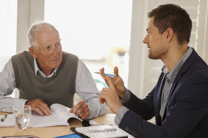 A young businessman discussing with a senior client.